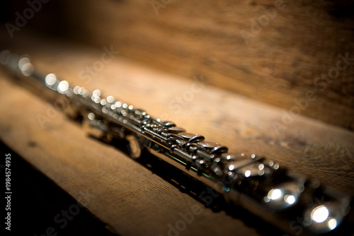 Silver Flute Musical Instrument On Wooden Surface Closeup