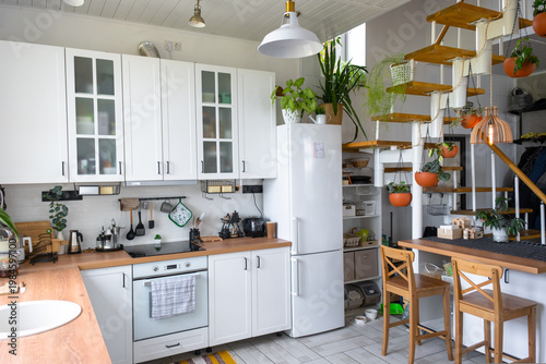 Fotografija Homely kitchen with wooden modular stairs, potted plants everywhere, open shelving, light color palette, eco-interior, compact design, practical and inviting