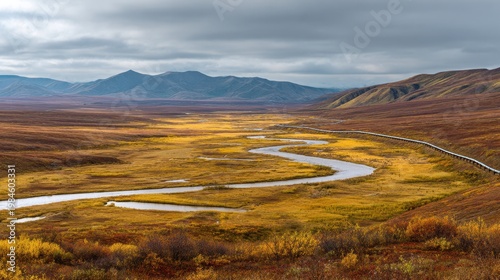 Autumn tundra panorama with winding river and oil pipeline across Alaska's North Slope
