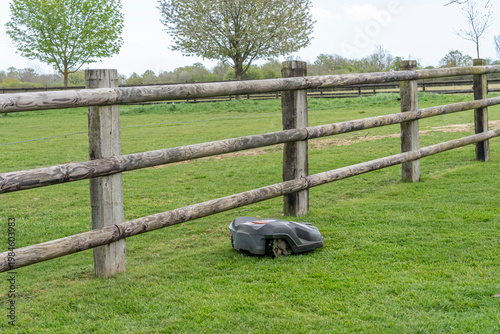 Photography Charencey, France - 04 12 2026: A robotic lawnmower automatically mows the lawns