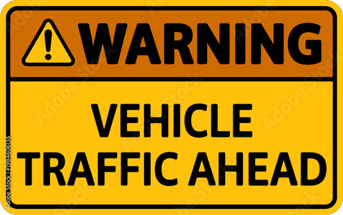 Yellow and orange road sign warning of vehicle traffic ahead