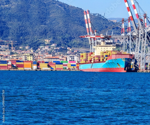Modern cargo container terminal with many high cranes and containers