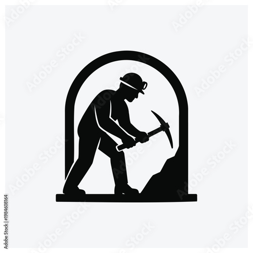 Silhouette of a miner working in a mine tunnel