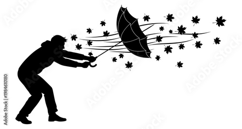 Person struggling with umbrella during strong wind and falling leaves