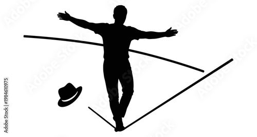 Silhouette of a man balancing on a tightrope with his hat flying off during a daring performance