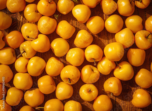 Yellow cherry on a wooden background. Top view. Flat lay.