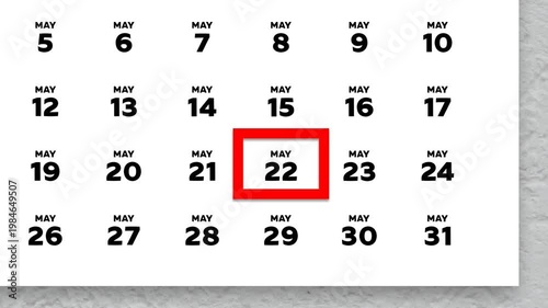 The date May 22nd marked with a red cursor on the wall calendar 2026