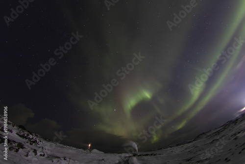 Aurora borealis over lighthouse geothermal steam Reykjanes Iceland