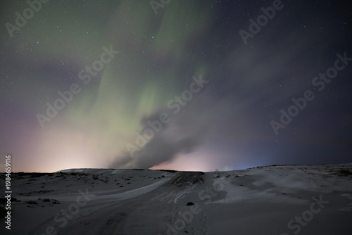 Aurora borealis over Gunnuhver geothermal hot spring vent Iceland
