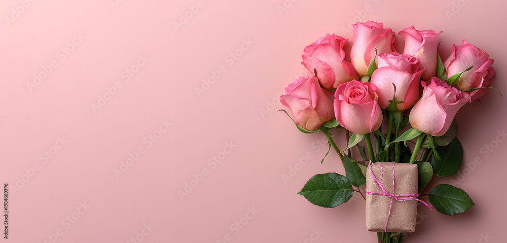 Fototapeta premium Pink roses bouquet with small gift box on pastel background copy space
