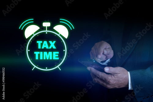Businessman with glowing Tax Time icon. E-tax Tax payment, TAX online payment and technology concept. the income tax online return form for payment. Financial research