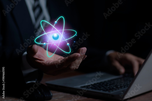 Businessman hand holding creative atom icon in palm. Nuclear fusion concept, endless energy, cheap electricity, Innovative technologies, Future technologies. Science and future concept