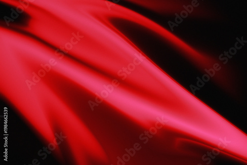 Vibrant red fabric texture with smooth folds and shadows on black