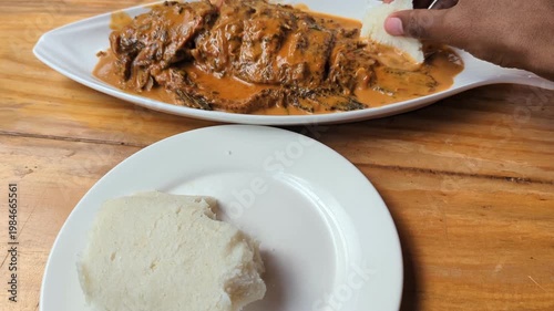 Ugali with Tilapia Coconut Fish Stew in Motion Video, Kenyan Cuisine Cornmeal Served with Creamy Fish Curry
