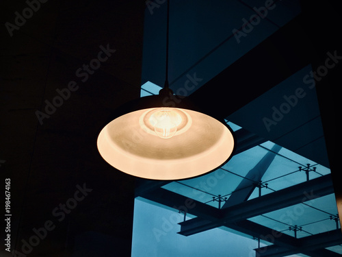 Minimalist Pendant Ceiling Lamp in Modern Architectural Interior with Skylight and Moody Evening Ambience