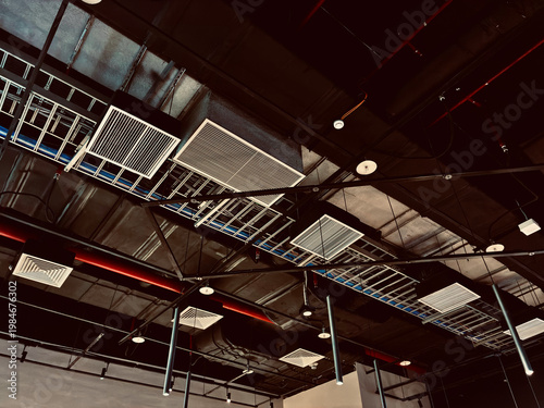 Modern Industrial Ceiling Interior with Exposed Ductwork, Acoustic Panels, and Contemporary Office Design