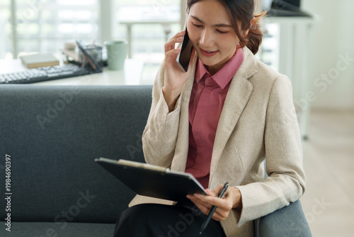 Schilderij op canvas Asian adult businesswoman phone call client discussion professional documents st