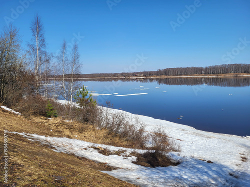 On a clear spring day, white ice floes float along the Volga River.