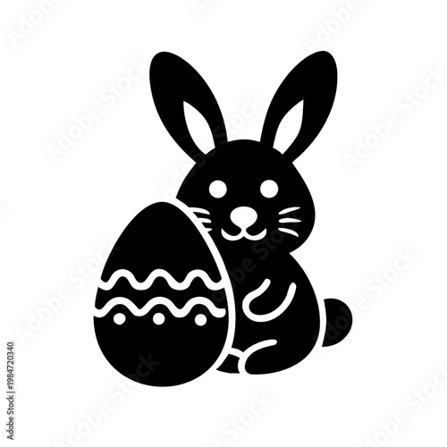 Black silhouette of a bunny holding an easter egg