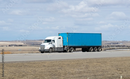 Heavy Cargo on the Road. A truck transporting cargo along a highway. Taken in Alberta, Canada