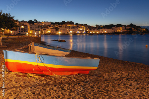 Fishing boats on the beach in Cadaques Bay, Catalonia, Spain.