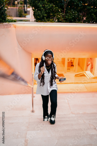 Vászonkép Young woman with vitiligo dancing and laughing while listening to music, happy g