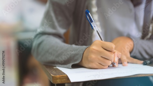Close-up of Student Writing on OMR Answer Sheet in Final Exam