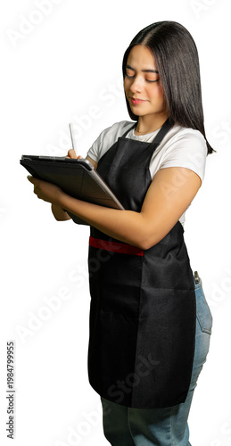 Young woman wearing an apron using a digital tablet with a stylus