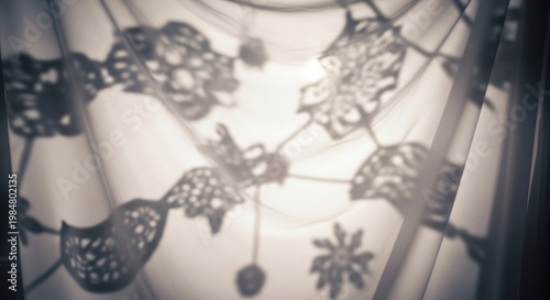 Ethereal light casting delicate ornamental shadows from intricate objects on a softly textured surface