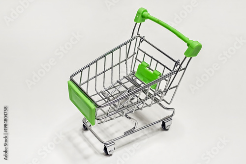 Tiny shopping cart with green handle and base