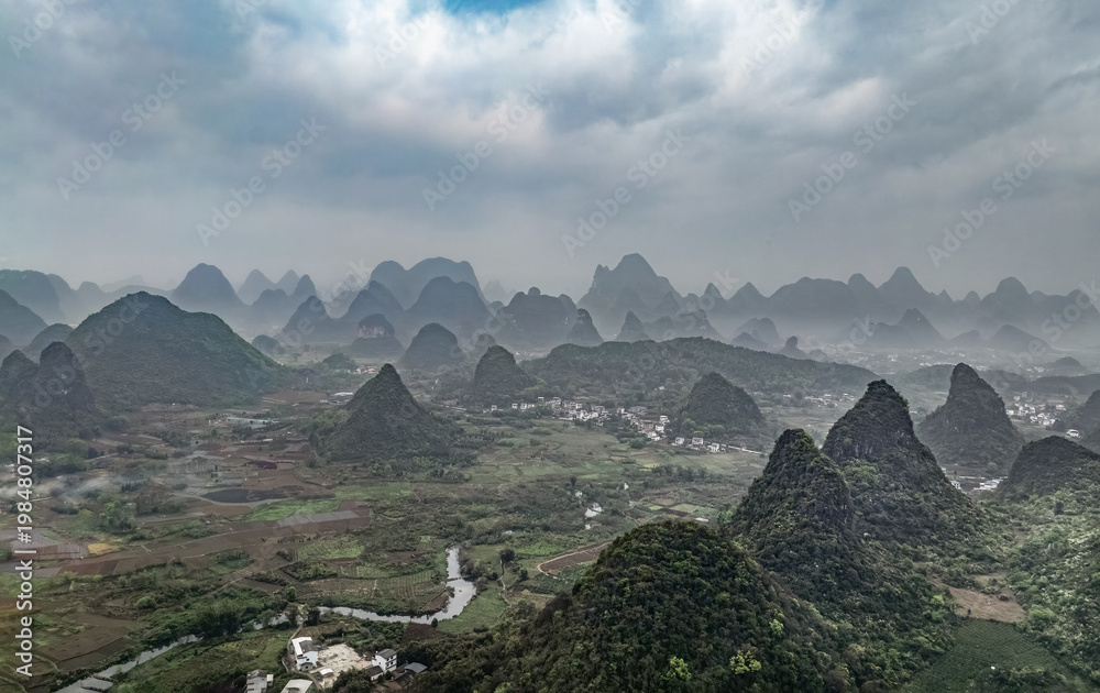 Obraz premium lush green valley surrounded by towering mountains. China.