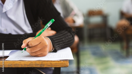 Close-up of Student Writing on OMR Answer Sheet in Final Exam