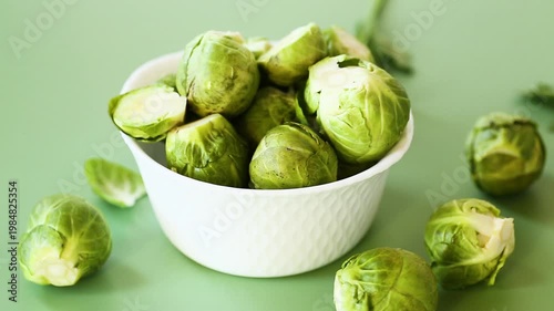 organic green brussels sprouts in bowl with natural herb garnish