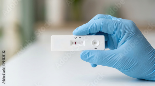 Gloved hand holding rapid test cassette medical glove healthcare laboratory diagnosis negative result prevention pandemic safety