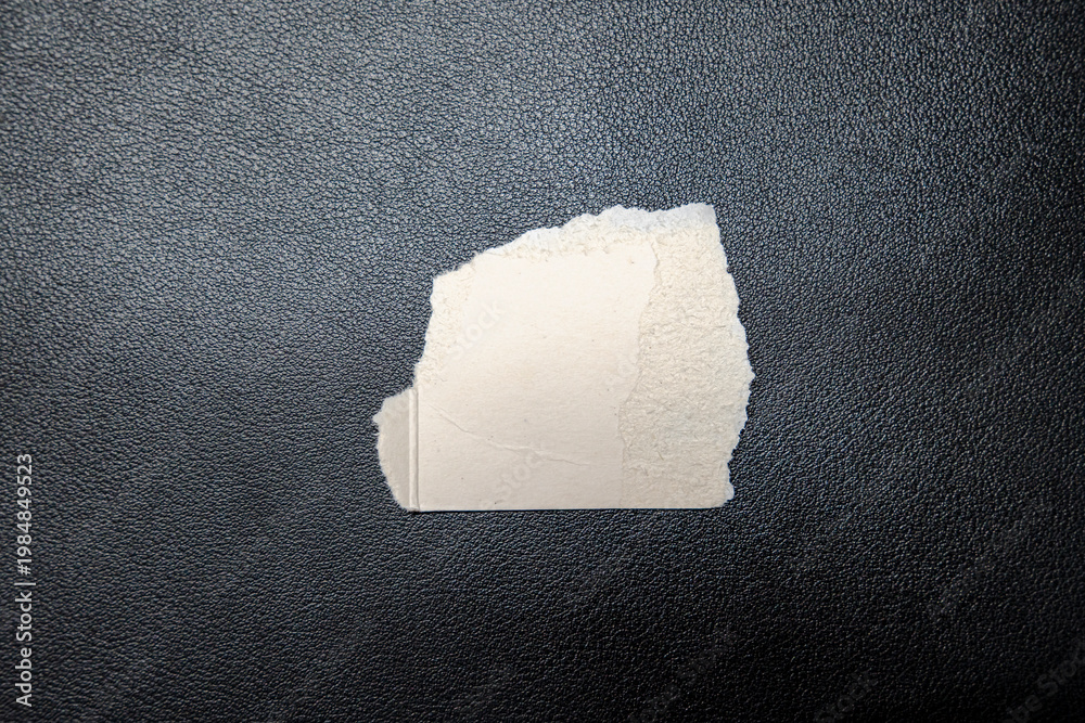 Ταπετσαρία Torn piece of paper on a black leather surface, representing concepts of impermanence and creativity