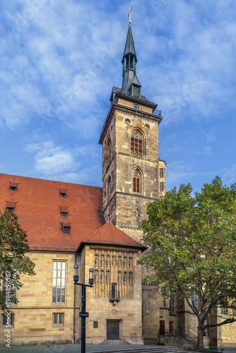 Bell tower of Stiftskirche church in Stuttgart, Germany. Gothic architecture of the historical landmark under cloudy sky