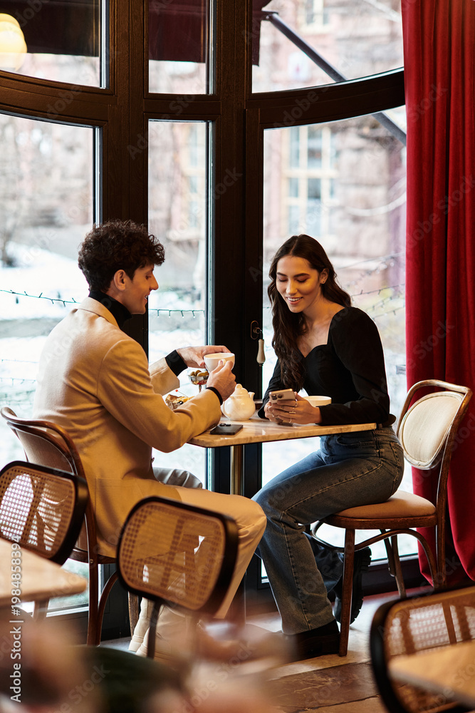 Fototapeta premium Romantic young couple enjoying a special moments at an elegant restaurant