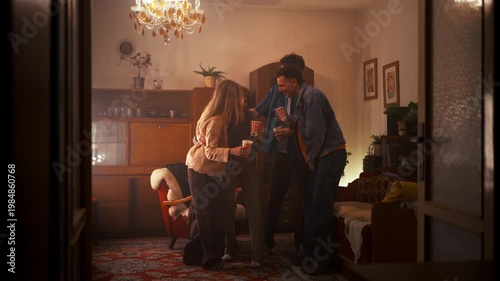 Best friends celebrating together, drinking and having fun at night house party.