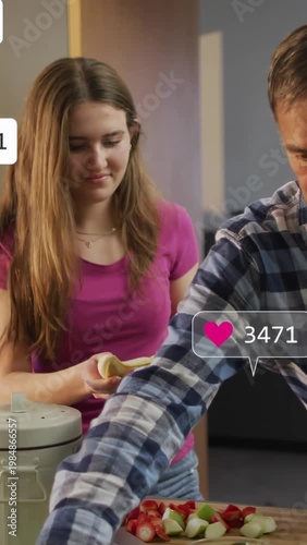Vertical video: Teen peeling banana dad lifting celery sparking social likes over counter for snack