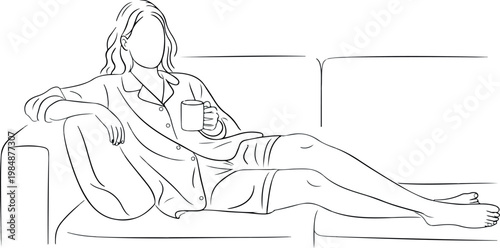 Woman sitting on sofa with mug, enjoying comfortable leisure time at home.