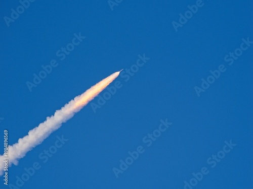 April 1, 2026 Artemis II  rocket launch climbing  with trailing thin bright flaming exhaust gasses
