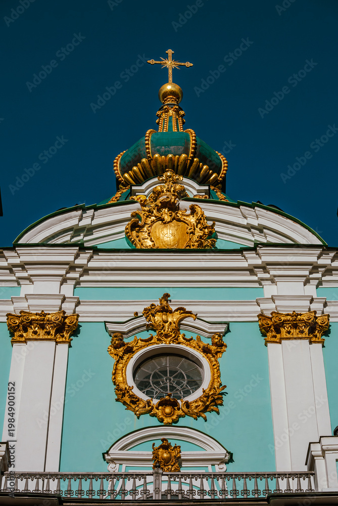 Obraz premium Intricate golden decorations on turquoise wall of old orthodox cathedral