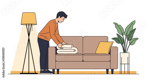 Man tidies up living room, folding blanket on sofa near lamp and plant
