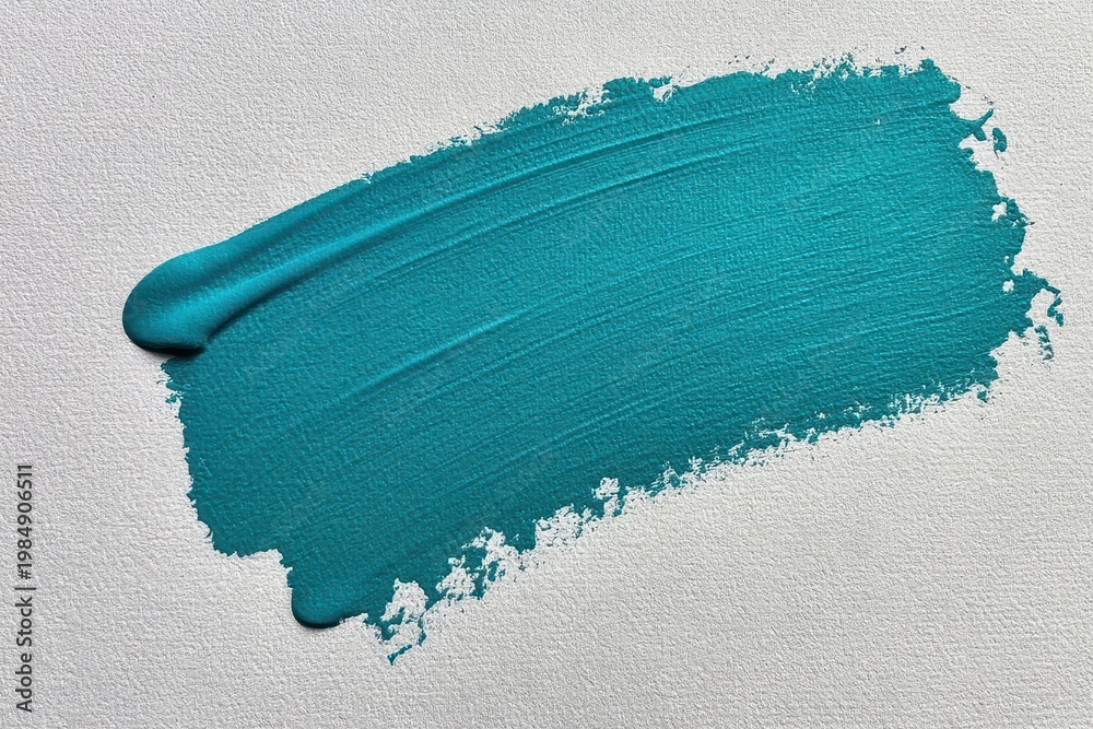 Fototapeta premium A textured teal paint stroke across a white textured paper background, abstract artistic brush mark.
