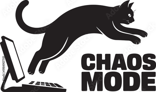 Black cat leaping towards computer keyboard and screen