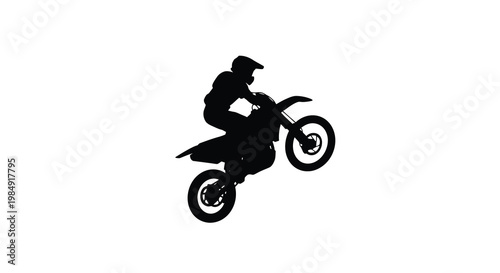 Silhouette of a motocross rider performing a dramatic jump in mid air