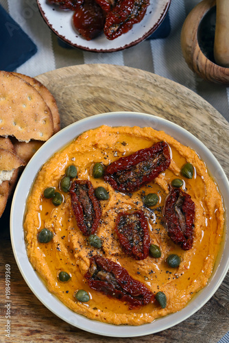 Hummus with sun-dried tomatoes and capers