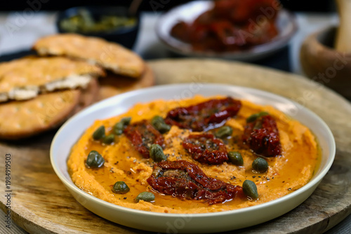 Hummus with sun-dried tomatoes and capers