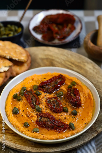 Hummus with sun-dried tomatoes and capers