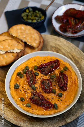 Hummus with sun-dried tomatoes and capers